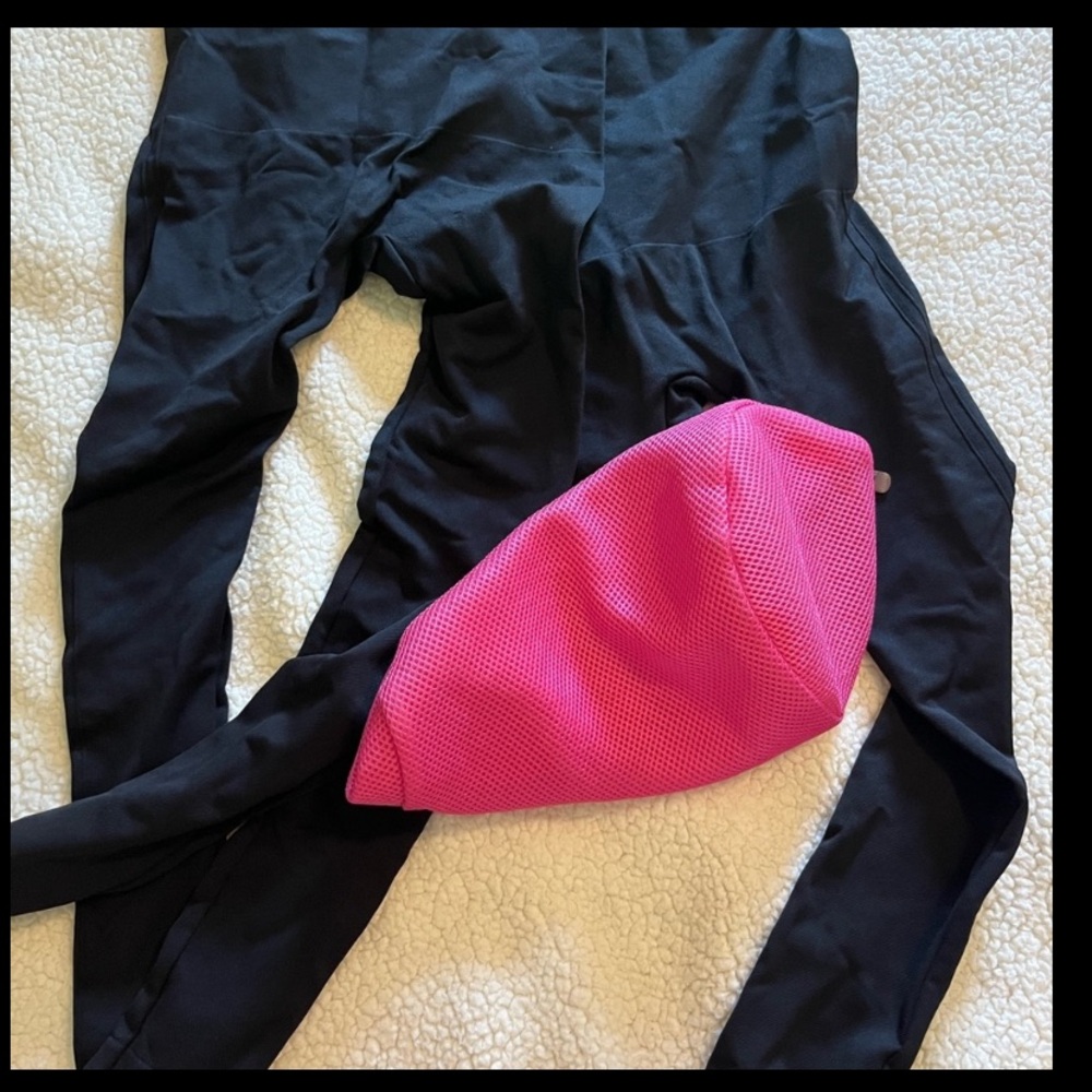 Lot of compression leggings along with the Pink Mesh Women's Bag for washing.